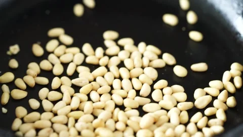 Toasting pine nuts in skillet Stock Footage 156646911