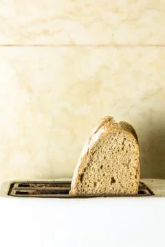 Toasting a slices of bread to make toast in the morning. Concept of breakfast Stock Photos