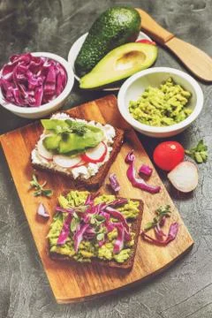 Toasts with Avocado and Vegetables Stock Photos