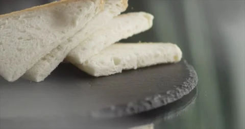 Toasts fall on a black surface Stock Footage 198701456