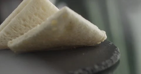 Toasts fall on a black surface in slow motion Stock Footage 197702492