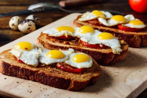 Toasts with Fried Eggs on Cutting Board Stock Photos
