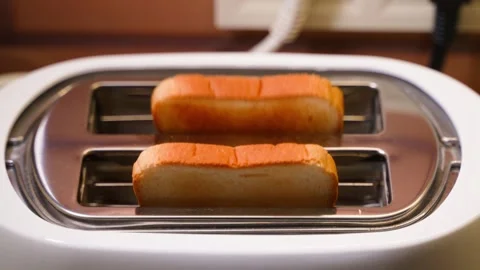 Toasts jumping out of the toaster, close-up Stock Footage 324698339