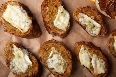 Toasts with layer of melted cheese, rustic comfort food Stock Photos