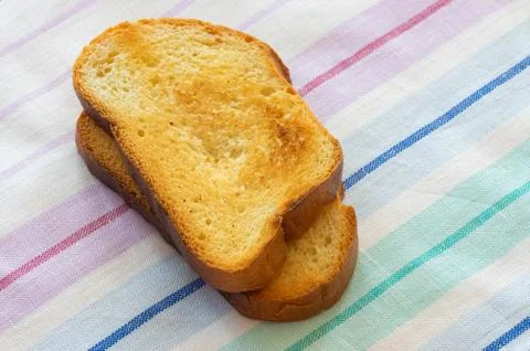 Toasts lying on a table-cloth Stock Photos