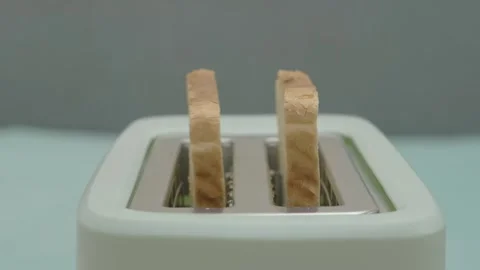 Toasts made from slices of bread pop out of the toaster Stock-Footage 264092369
