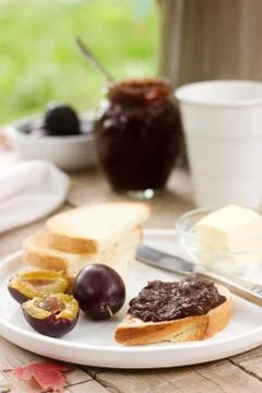 Toasts with plum chocolate jam and cocoa. Breakfast in the garden. Rustic sty Stock Photos