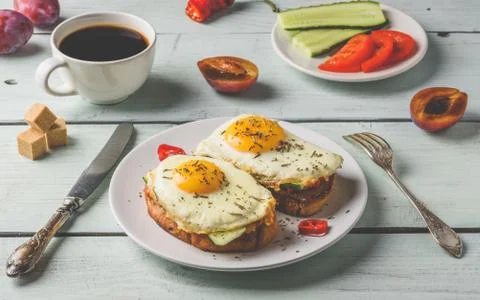 Toasts with vegetables and fried egg and cup of coffee Stock Photos