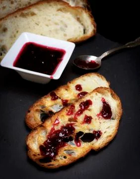 Toasts of white bread and raspberry jam Stock Photos