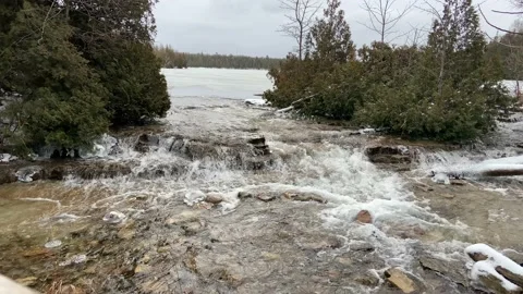 Tobermory, Canada, December 16, 2020: editorial video of waterfall from lake Stock Footage 147010124