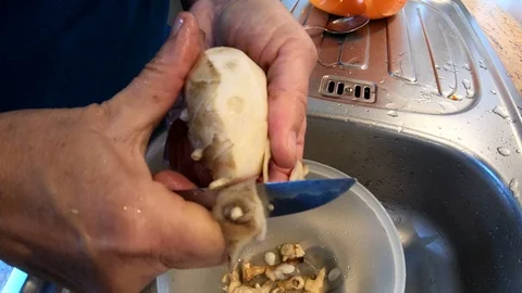 Tobinambur peeling in kitchen, handmade, authentic works, homemade, 4K Video stock 97952662