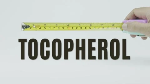 Tocopherol text or word and tape measure on a white background Vídeo Stock 302122216