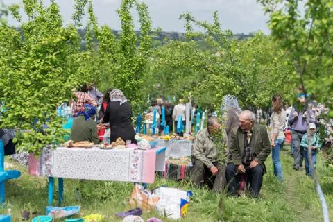 TOCUZ, MOLDOVA- 9 MAY, 2016: People in the cemetery celebrating the dead duri Stock Photos