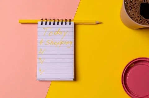 Today plans wrote on a spiral notebook. Cup of coffee on a colorful table Stock Photos