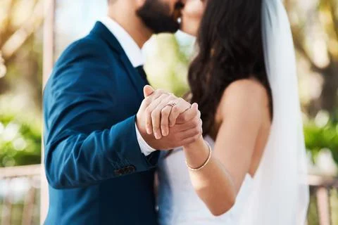 Today they chose commitment. an unrecognizable newlywed couple kissing while Stock Photos