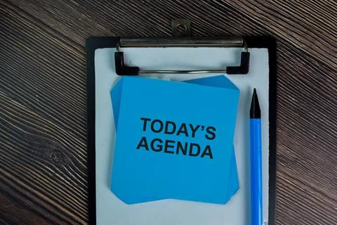 Today's Agenda write on sticky notes isolated on Wooden Table. Stock Photos