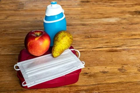 Todays lunchbox contains mouth mask, COVID19 Stock Photos