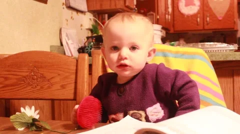 Toddler attempts to brush her short hair Stock Footage 45706505