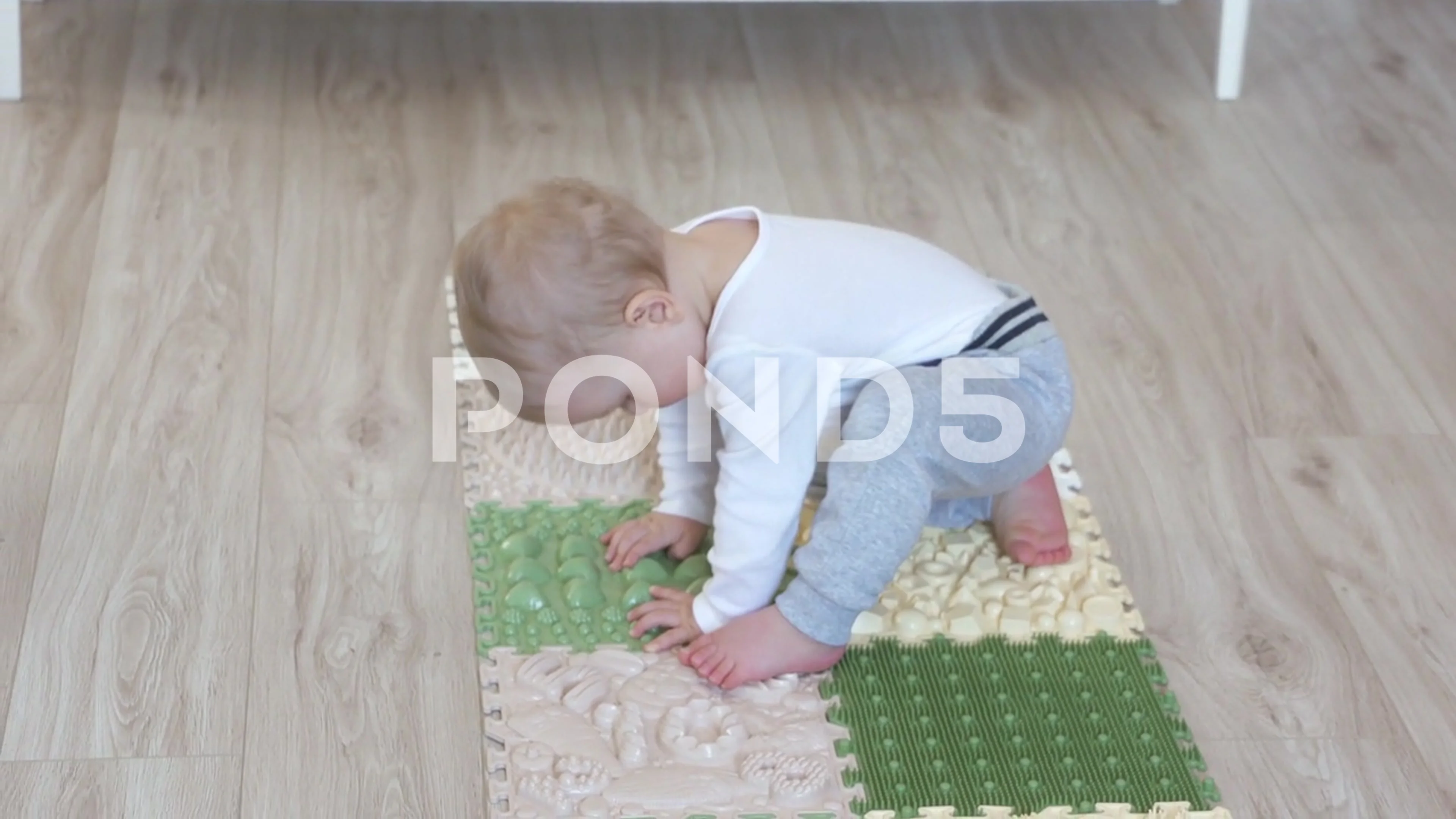 https://images.pond5.com/toddler-baby-foot-massage-mat-footage-181945679_prevstill.jpeg