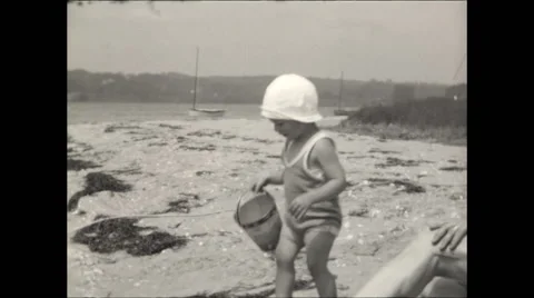 Toddler on beach with bucket Video stock 56161979