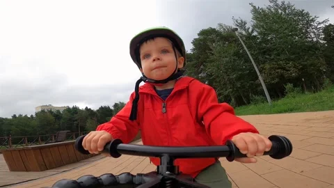 Toddler boy (2,5 year old) is riding on the balance bike. Action camera Stock Footage 252262447
