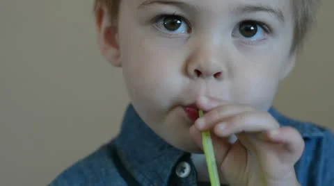 Toddler boy drinking through straw playing with mouth 4069 Stock Footage 11158725