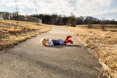 Toddler boy having a tantrum on walking path Stock Photos