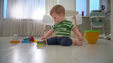 Toddler boy is playing with educational geometric sorter at home. Early Video stock 262148390