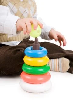 The toddler boy plays developing game. color pyramidion. Stock Photos