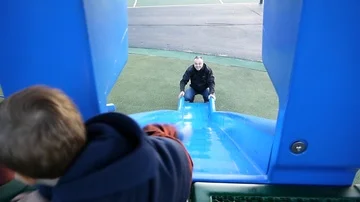 Toddler boy riding down the slide Stock Footage 85676269