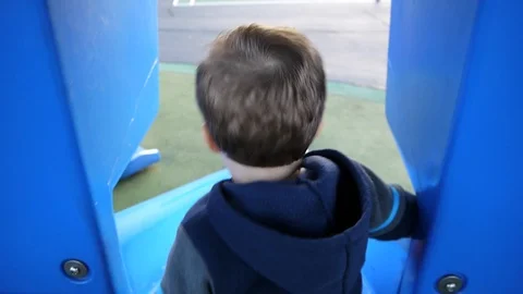Toddler boy riding down the slide Stock Footage 85676363