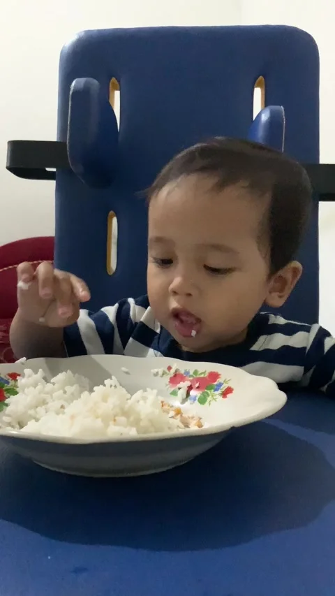 Toddler Boy Sitting at Blue Plastic Desk Indoors Stock Footage 338161759
