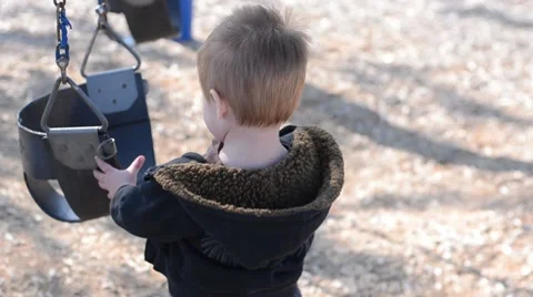 Toddler boy walking towards swing 8042 Stock Footage 10749100