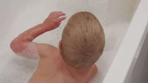 Toddler child taking a bubble bath Stock Footage 240930064