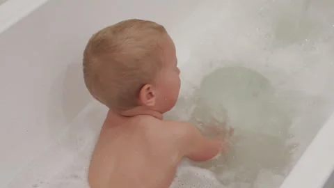 Toddler child taking a bubble bath Stock Footage 240930314