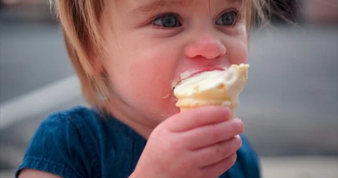 Toddler chowing down on vanilla ice cream Stock Footage 109561373