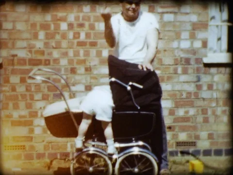Toddler Climbing stroller dad flips off camera Vintage 1960s 1970s 1950s Stock Footage 81493193