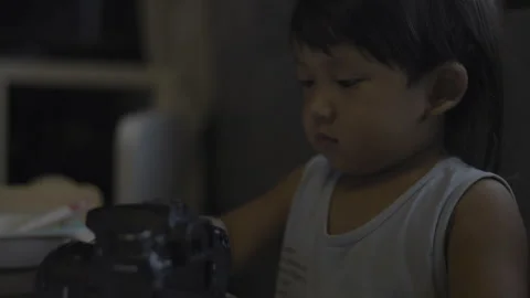 Toddler Is Curiously Exploring The DSLR Camera With Tiny Hands 01 Stock Footage 313431770