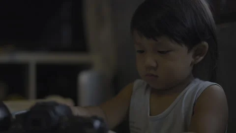 Toddler Is Curiously Exploring The DSLR Camera With Tiny Hands 02 Stock Footage 329211960