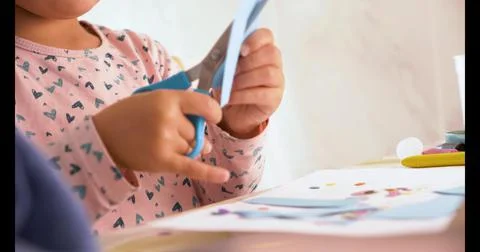 Toddler cutting with scissors and doing crafts Stock Photos