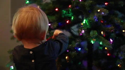 Toddler decorating Christmas tree Stock Footage 58074351