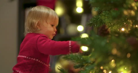 Toddler decorating christmas tree Stock Footage 143710297