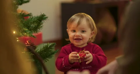 Toddler decorating christmas tree Stock Footage 143712903