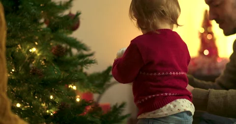 Toddler decorating christmas tree Stock Footage 143713479