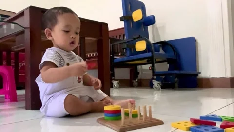 Toddler Developing Fine Motor Skills with Occupational Shape Sorter Stock Footage 328296536