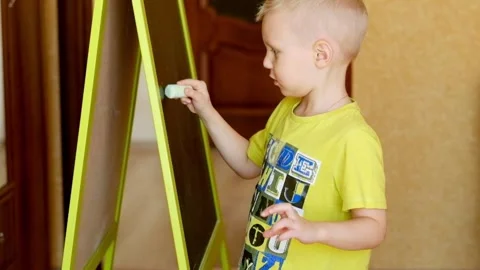 Toddler drawing at the blackboard Stock Footage 87948517