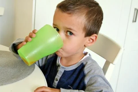 Toddler drinking juice Stock Photos