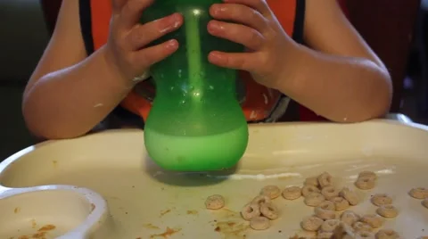 Toddler drinking milk from a sippy cup Stock Footage 44446594