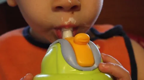 Toddler Drinking Milk from a Sippy Cup Stock Footage 44446618