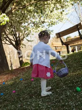 Toddler on easter egg hunt Stock Photos